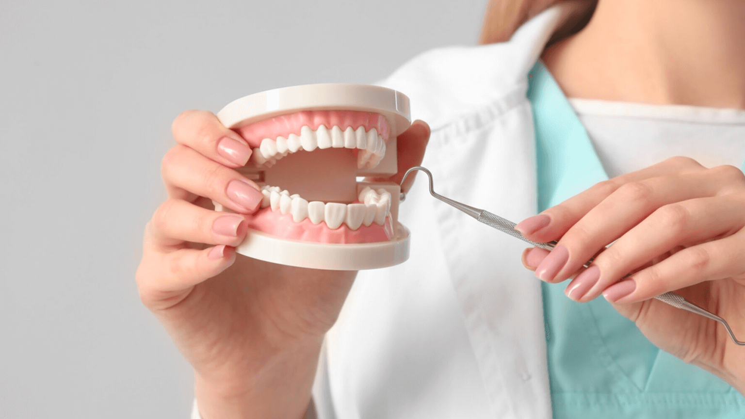 Why You Shouldn’t Ignore Your Teeth_ A dental professional demonstrating the use of a dental pick on a model of teeth